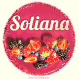 Beautifully decorated red velvet berry birthday cake with vibrant fruits and a glowing 'Soliana' name, adding a touch of sweetness and sparkle.