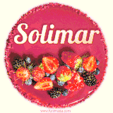 Beautifully decorated red velvet berry birthday cake with vibrant fruits and a glowing 'Solimar' name, adding a touch of sweetness and sparkle.