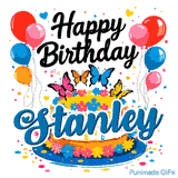 Vibrant clusters of red, pink, blue, and orange balloons on both sides of a decorative butterfly-themed cake for Stanley.