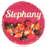 Beautifully decorated red velvet berry birthday cake with vibrant fruits and a glowing 'Stephany' name, adding a touch of sweetness and sparkle.