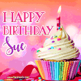 A vibrant birthday GIF featuring a rainbow-colored cupcake topped with white frosting, sprinkles, and a lit candle. The text reads 'Happy Birthday Sue' in bold pink and violet letters with white outline.