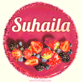 Beautifully decorated red velvet berry birthday cake with vibrant fruits and a glowing 'Suhaila' name, adding a touch of sweetness and sparkle.