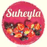 Beautifully decorated red velvet berry birthday cake with vibrant fruits and a glowing 'Suheyla' name, adding a touch of sweetness and sparkle.