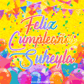 A bright and festive GIF with the text 'Feliz Cumpleaños Suheyla' in Spanish in colorful fonts, surrounded by confetti, balloons, and festive banners on a vibrant yellow background.
