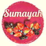 Beautifully decorated red velvet berry birthday cake with vibrant fruits and a glowing 'Sumayah' name, adding a touch of sweetness and sparkle.