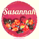 Beautifully decorated red velvet berry birthday cake with vibrant fruits and a glowing 'Susannah' name, adding a touch of sweetness and sparkle.