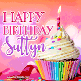 A vibrant birthday GIF featuring a rainbow-colored cupcake topped with white frosting, sprinkles, and a lit candle. The text reads 'Happy Birthday Suttyn' in bold pink and violet letters with white outline.