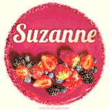 Beautifully decorated red velvet berry birthday cake with vibrant fruits and a glowing 'Suzanne' name, adding a touch of sweetness and sparkle.