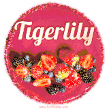 Beautifully decorated red velvet berry birthday cake with vibrant fruits and a glowing 'Tigerlily' name, adding a touch of sweetness and sparkle.