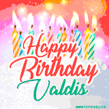 Bright birthday candles with rainbow flames on a cake, alongside the text 'Happy Birthday Valdis' in vibrant script in this celebratory animated GIF.