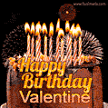 A rich chocolate cake topped with glowing birthday candles and surrounded by bright fireworks. The animated GIF displays the message 'Happy Birthday Valentine' in golden text.