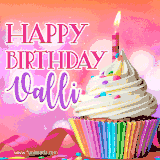 A vibrant birthday GIF featuring a rainbow-colored cupcake topped with white frosting, sprinkles, and a lit candle. The text reads 'Happy Birthday Valli' in bold pink and violet letters with white outline.