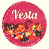 Beautifully decorated red velvet berry birthday cake with vibrant fruits and a glowing 'Vesta' name, adding a touch of sweetness and sparkle.