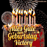 A chocolate birthday cake with glowing candles, the German text 'Alles Gute zum Geburtstag Victory,' and vibrant fireworks lighting up the background in an animated GIF.