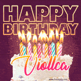A colorful birthday cake topped with lit candles, with the words 'Happy Birthday Viollca' in bold glowing letters on a burgundy background. Animated flames add a festive touch.