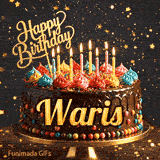 A decorated birthday cake with colorful frosting rosettes, glowing candles, and a golden Happy Birthday topper with the name Waris.