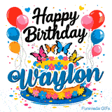 White drip cake on a blue platter with the name Waylon, surrounded by confetti, colorful hearts, and balloons.