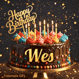 Burning birthday candles on top of a chocolate drip cake decorated with colorful icing dollops and sprinkles for Wes.