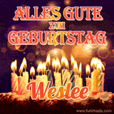 An animated GIF featuring 'Alles Gute Zum Geburtstag Weslee' in glowing red and gold letters above a cake with colorful lit candles, set against a festive sparkling background.