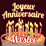 A Happy Birthday GIF in French featuring a festive birthday cake adorned with bright candles and the glowing text 'Joyeux Anniversaire Weslee' in a cheerful style.
