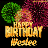 A captivating GIF with bursts of green, pink, and orange fireworks lighting up the night sky, accompanied by 'Happy Birthday Weslee' in glowing golden text.