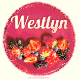 Beautifully decorated red velvet berry birthday cake with vibrant fruits and a glowing 'Westlyn' name, adding a touch of sweetness and sparkle.