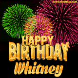A captivating GIF with bursts of green, pink, and orange fireworks lighting up the night sky, accompanied by 'Happy Birthday Whitney' in glowing golden text.