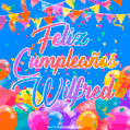 A vibrant animated GIF with 'Feliz Cumpleaños Wilfred' written in colorful script, surrounded by balloons, confetti, and bunting on a bright blue background.