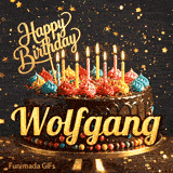 Burning birthday candles on top of a chocolate drip cake decorated with colorful icing dollops and sprinkles, personalized for Wolfgang.