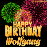 A captivating GIF with bursts of green, pink, and orange fireworks lighting up the night sky, accompanied by 'Happy Birthday Wolfgang' in glowing golden text.