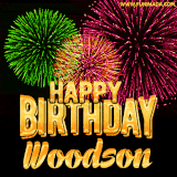 A captivating GIF with bursts of green, pink, and orange fireworks lighting up the night sky, accompanied by 'Happy Birthday Woodson' in glowing golden text.