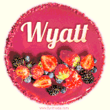 Beautifully decorated red velvet berry birthday cake with vibrant fruits and a glowing 'Wyatt' name, adding a touch of sweetness and sparkle.