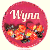 Beautifully decorated red velvet berry birthday cake with vibrant fruits and a glowing 'Wynn' name, adding a touch of sweetness and sparkle.