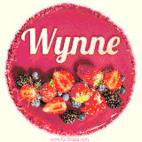 Beautifully decorated red velvet berry birthday cake with vibrant fruits and a glowing 'Wynne' name, adding a touch of sweetness and sparkle.