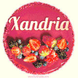 Beautifully decorated red velvet berry birthday cake with vibrant fruits and a glowing 'Xandria' name, adding a touch of sweetness and sparkle.