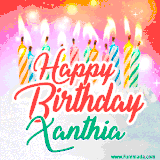 Bright birthday candles with rainbow flames on a cake, alongside the text 'Happy Birthday Xanthia' in vibrant script in this celebratory animated GIF.