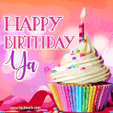 A vibrant birthday GIF featuring a rainbow-colored cupcake topped with white frosting, sprinkles, and a lit candle. The text reads 'Happy Birthday Ya' in bold pink and violet letters with white outline.