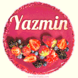 Beautifully decorated red velvet berry birthday cake with vibrant fruits and a glowing 'Yazmin' name, adding a touch of sweetness and sparkle.