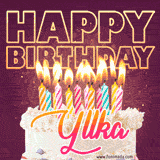 A colorful birthday cake topped with lit candles, with the words 'Happy Birthday Yllka' in bold glowing letters on a burgundy background. Animated flames add a festive touch.