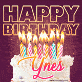 A colorful birthday cake topped with lit candles, with the words 'Happy Birthday Ynes' in bold glowing letters on a burgundy background. Animated flames add a festive touch.