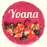 Beautifully decorated red velvet berry birthday cake with vibrant fruits and a glowing 'Yoana' name, adding a touch of sweetness and sparkle.