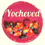 Beautifully decorated red velvet berry birthday cake with vibrant fruits and a glowing 'Yocheved' name, adding a touch of sweetness and sparkle.