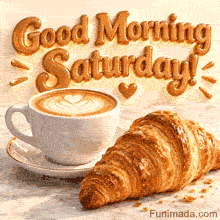Steaming coffee with leaf foam art and a fresh croissant rest on marble under the shining Good Morning Saturday text in warm golden tones