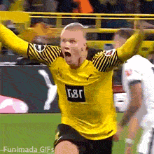Erling Haaland wearing a yellow and black striped Borussia Dortmund kit screams in pure joy and raises his hands in a triumphant, dramatic gesture on the field.