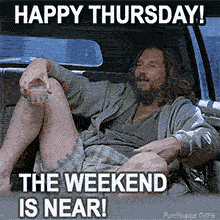 The Dude from 'The Big Lebowski' relaxes in the back of a car, holding a White Russian. He wears a zip-up hoodie and plaid shorts, smiling contentedly under 'Happy Thursday!' text.