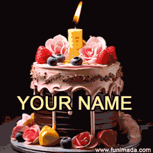 A luxurious birthday cake with dark layers, pastel pink icing, golden trim, and edible flower decorations, topped with fruit and a flickering candle against a black backdrop.