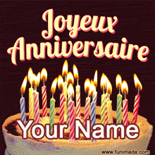 Animated French birthday GIF with a cake topped by many glowing colorful candles and elegant 'Joyeux Anniversaire' script on a dark background